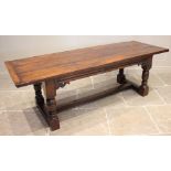 A 17th century style oak refectory table, the early three plank cleated top above an invert