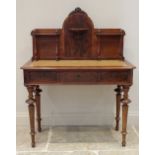 A 19th century and later mahogany writing table, the shaped high back with four slender pilasters,
