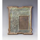 An Arts & Crafts copper photograph frame, late 19th or early 20th century, embossed with a harvest