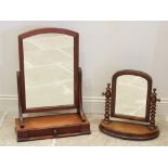 A Victorian mahogany dressing table mirror, the arched mirrored plate raised upon curved supports