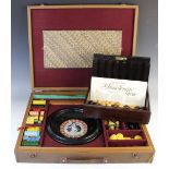 A 20th century cased gaming compendium, containing a Roulette wheel, counters and chess pieces, with
