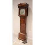 A George III oak cased eight day longcase clock, the pagoda shaped hood with freestanding tapering