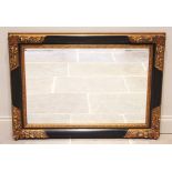 A 19th century style gilt and ebonised rectangular composite wall mirror, late 20th century, the