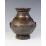 A Chinese polished bronze Archaic vase, of compressed baluster form and decorated with archaic