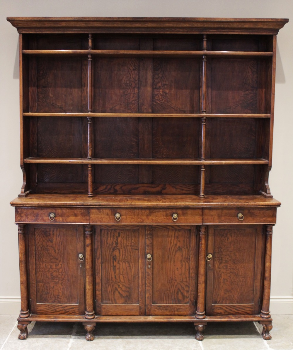 A mid 19th century elm dresser, possibly French, the high back with a moulded cornice over three