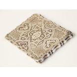 A Victorian silver card case by George Unite, Birmingham 1872, of shaped rectangular form, chased