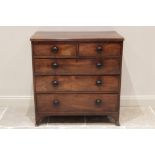 A George III mahogany chest of drawers, the rectangular top with a reeded edge over an arrangement