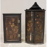 A 19th century Japanned bowfront hanging corner cupboard, the twin doors applied with painted detail