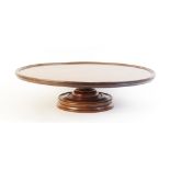 A 19th century mahogany Lazy Susan, of typical form with turned pedestal base and revolving circular