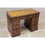 A late 19th century mahogany twin pedestal desk, the rectangular moulded top inset with a leather