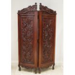 A late 19th/early 20th century carved walnut Rococo style twin panel screen, each screen with a