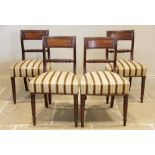 A matched set of eight Regency mahogany dining chairs, each with a rope twist rail back above a