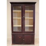 A Victorian stained pine kitchen cabinet, the moulded cornice above a pair of glazed doors opening