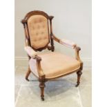 A French walnut salon chair, circa 1880, the arched button back below leaf and berry carved detail