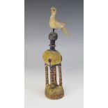 LATIN AMERICAN FOLK ART: A painted wooden sculpture, naively carved as a bird surmounting a ball