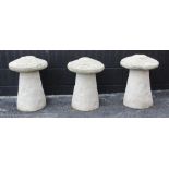 A trio of reconstituted stone staddle stones, each of typical mushroom form, 58cm high