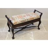 An Edwardian mahogany Chippendale revival duet piano stool, the hinged tapestry and upholstered