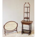 An early 20th century oak nest of three tea tables, each with a rectangular top raised upon lyre