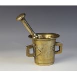 A Chinese bronze pestle and mortar, the polished bronze mortar with two lug handles and with