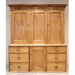A Victorian pine housekeepers cupboard, the moulded cornice above three invert moulded cupboard