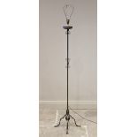 An early 20th century Arts and Crafts style wrought iron standard lamp, the square section column