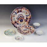 An Imari charger with shaped rim, 32cm diameter, with an Imari dish, 25cm diameter, a tea bowl and