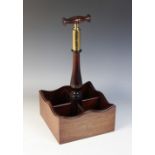 A mahogany four bottle tantalus, late 20th century, the baluster shaped central handle terminating