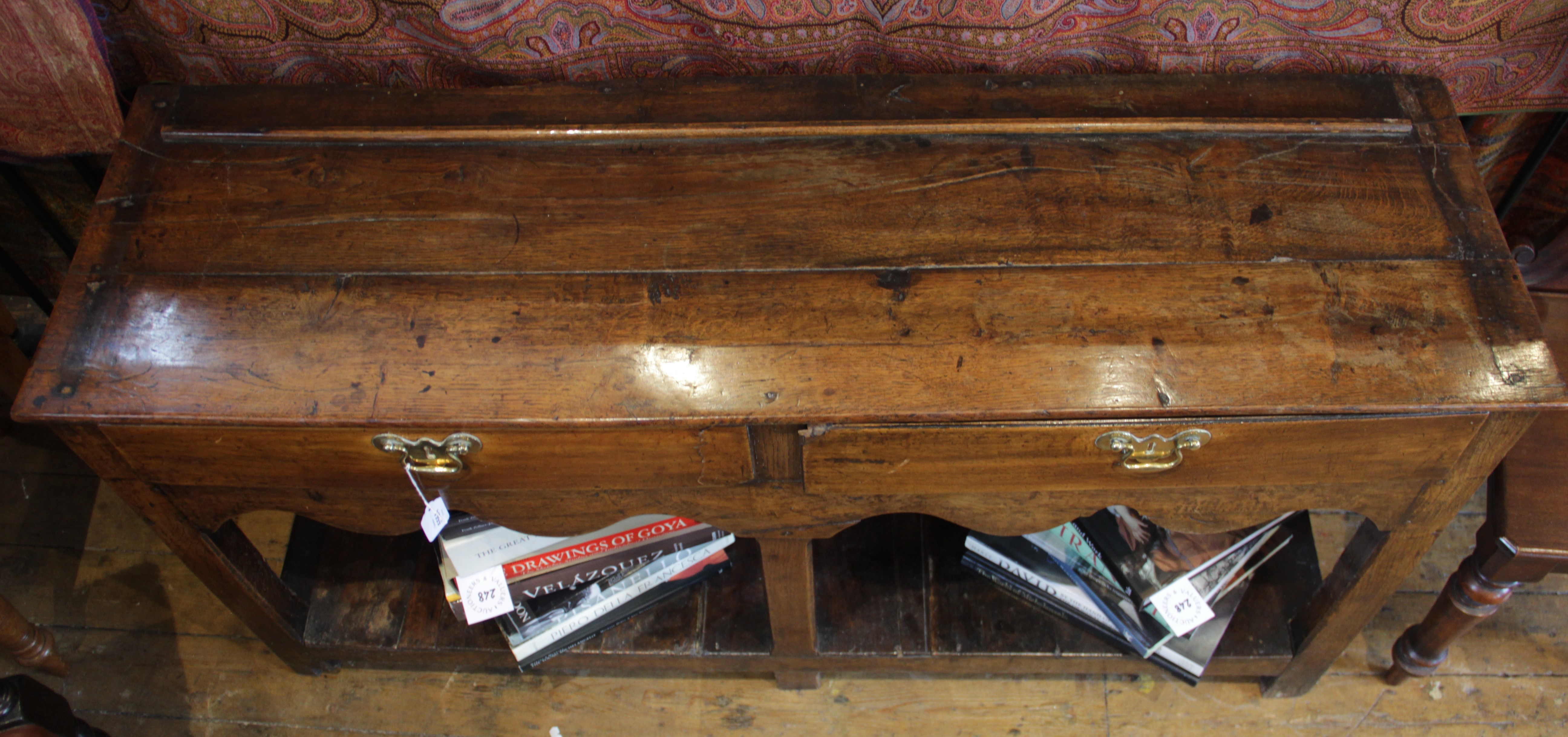 An 18th century oak dresser base, of cottage proportions, the two plank top above a pair of frieze - Image 2 of 3