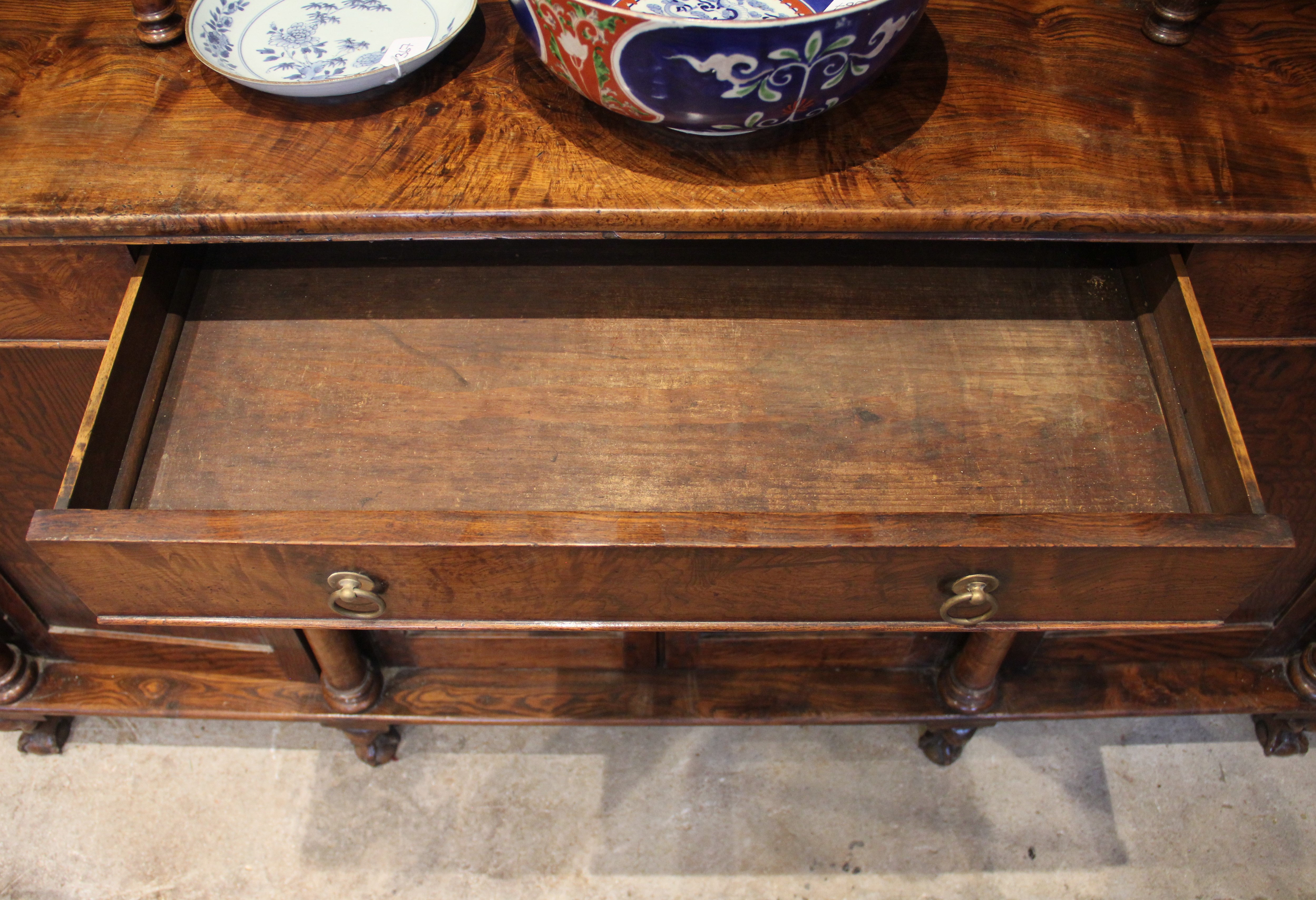 A mid 19th century elm dresser, possibly French, the high back with a moulded cornice over three - Image 8 of 15