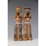 LATIN AMERICAN FOLK ART: A Peruvian bisque, glazed and painted terracotta figural group, modelled as