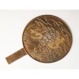 A Japanese polished bronze hand mirror, 20th century, of typical form and decorated with a crane