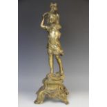 A cast brass figure of a young boy, 20th century, modelled with arms raised holding a cornucopia,