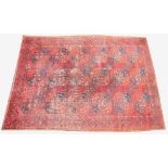 A large Bokhara carpet, woven in blue and red dyes with a traditional all-over elephants foot