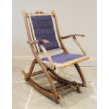 A late 19th century adjustable beech wood rocking chair, probably French, with a padded back rest