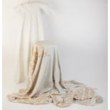 An Edwardian cotton christening gown, embroidered with foliate detail overlay, 102cm long, along