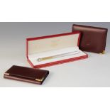 A Must de Cartier ballpoint pen, numbered 462563, silver coloured with brushed finish and gold