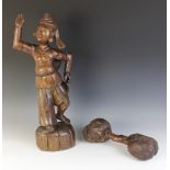 A large Burmese carved wooden figure depicting a male dancing, 62cm high, and a double ended