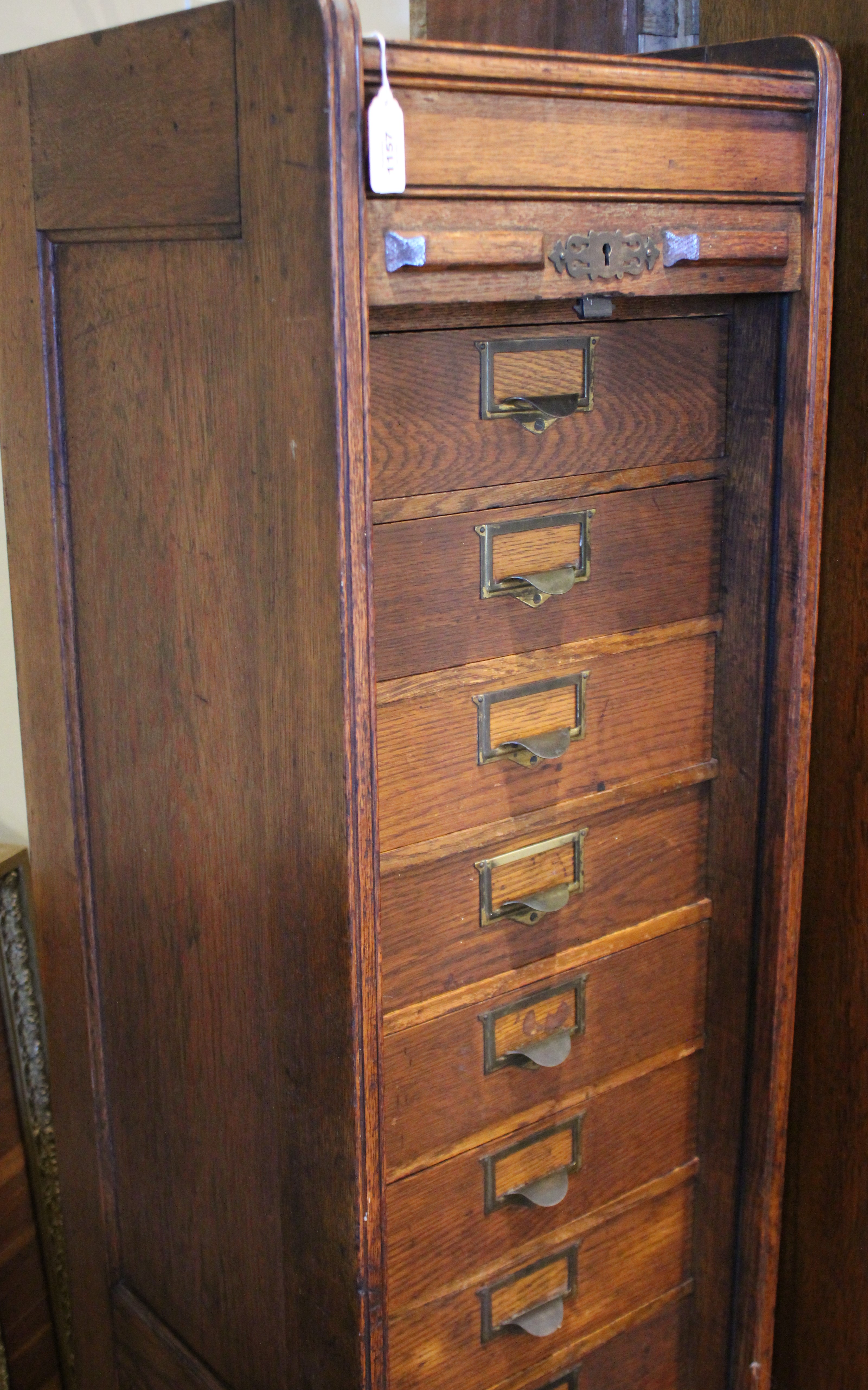 An early 20th century oak tambour front cabinet, of tall rectangular form with panelled sides, the - Bild 4 aus 8