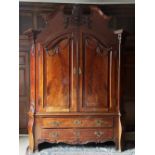 A large and impressive French Louis XVI style flame mahogany armoire, 19th century, the ornately