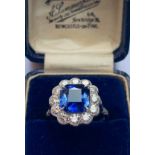 A sapphire and diamond cluster ring, the central octagonal mixed cut sapphire measuring 8.66mm x 8.