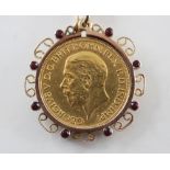 A George V gold full sovereign, dated 1929, set to a scrolling yellow metal mount set with small