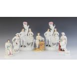 A pair of Staffordshire flat back figural groups, each designed as a couple seated upon a tree