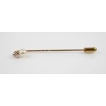 A diamond and pearl stick pin, comprising a round old cut diamond, estimated weight 0.15 ? 0.20