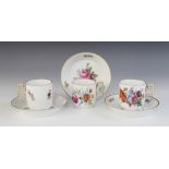 Three Meissen Marcolini period cups and saucers, circa 1810, each finely enamelled with bouquets