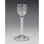 An engraved ogee bowl cordial glass, the bowl engraved with a six petalled rose and a bud with