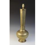 A Persian brass lamp base, applied with typical chased foliate detail, the tapering neck extending