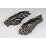 A pair of studio bronze hands, each modelled holding a grape vine, one inscribed ?Selina?, 28cm long