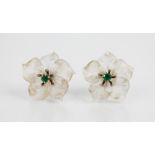 A pair of carved rock crystal and emerald floral earrings, each carved as a five-petal lily with