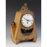 A Bavarian oak cased carved mantel clock, early 20th century, of pyramidal form surmounted with