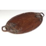 A Japanese carved hardwood tray, 20th century, the oval twin handled tray carved with grape vines